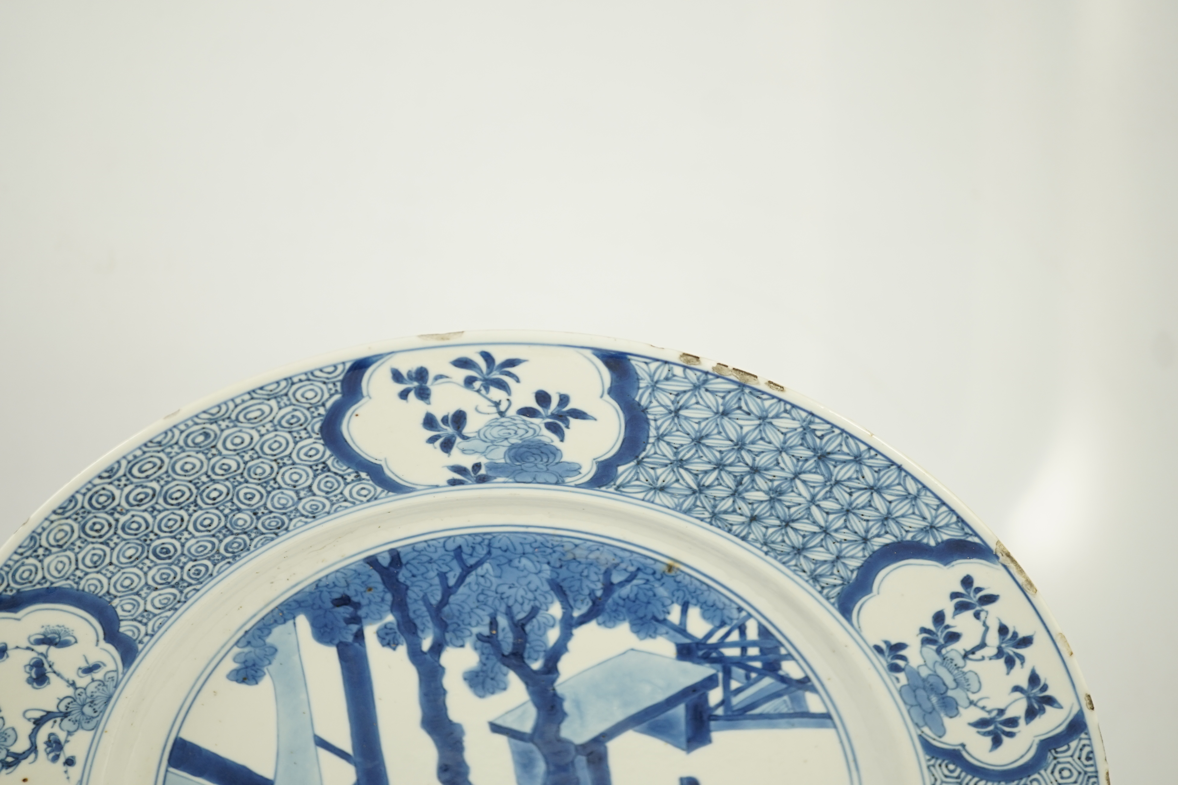 A Chinese blue and white ‘court scene’ dish, Kangxi period, two rim cracks and small splinter chips